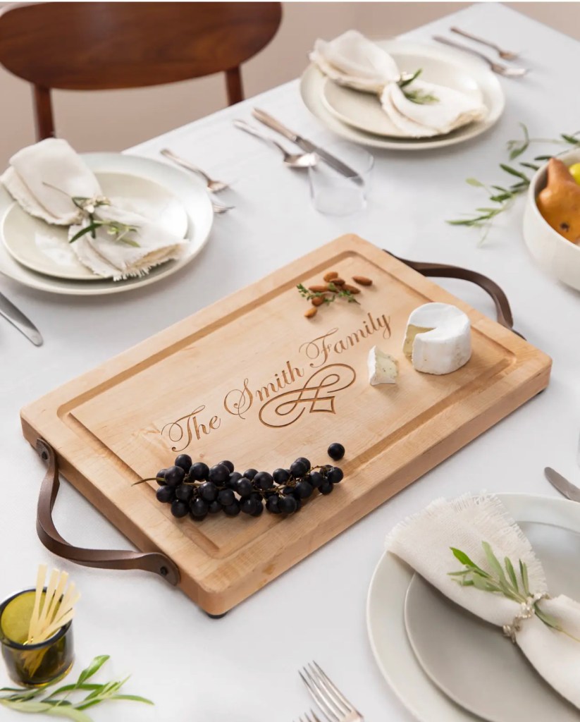 Wooden cutting board with light food propping on a set table