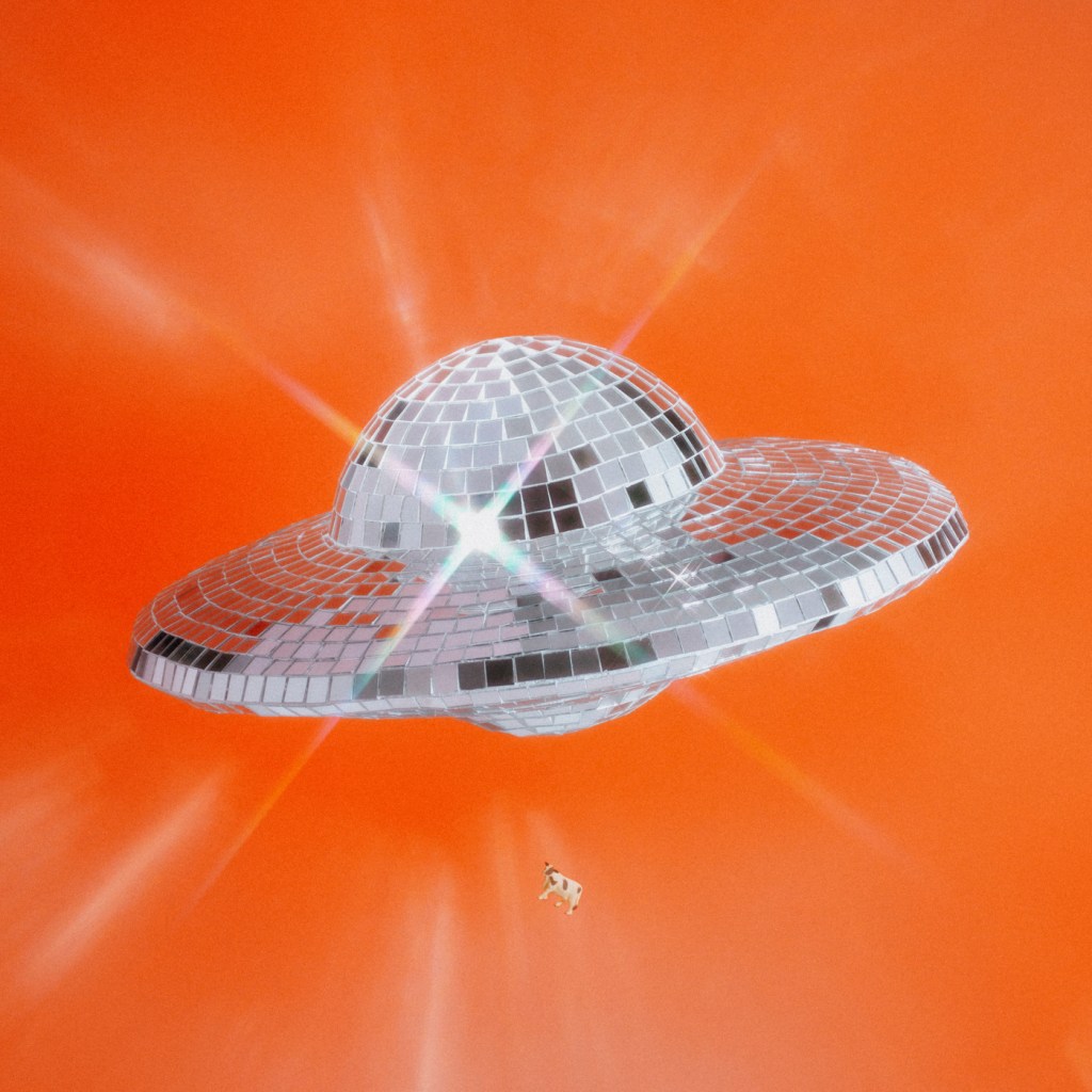 Faceted spaceship disco ball with levitating cow